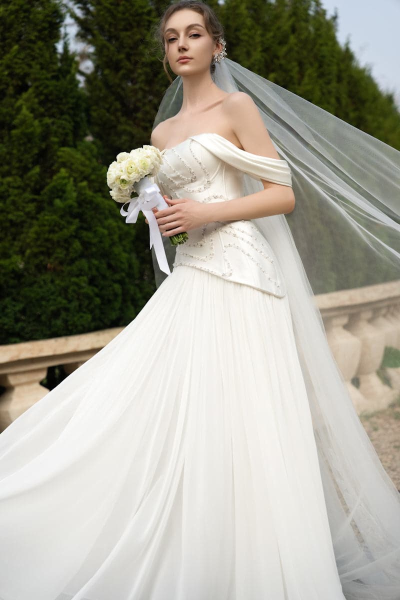 Elegant CULT MIA X 21Six Helena taffeta pleated gown with a flowing silhouette and intricate pleat details.