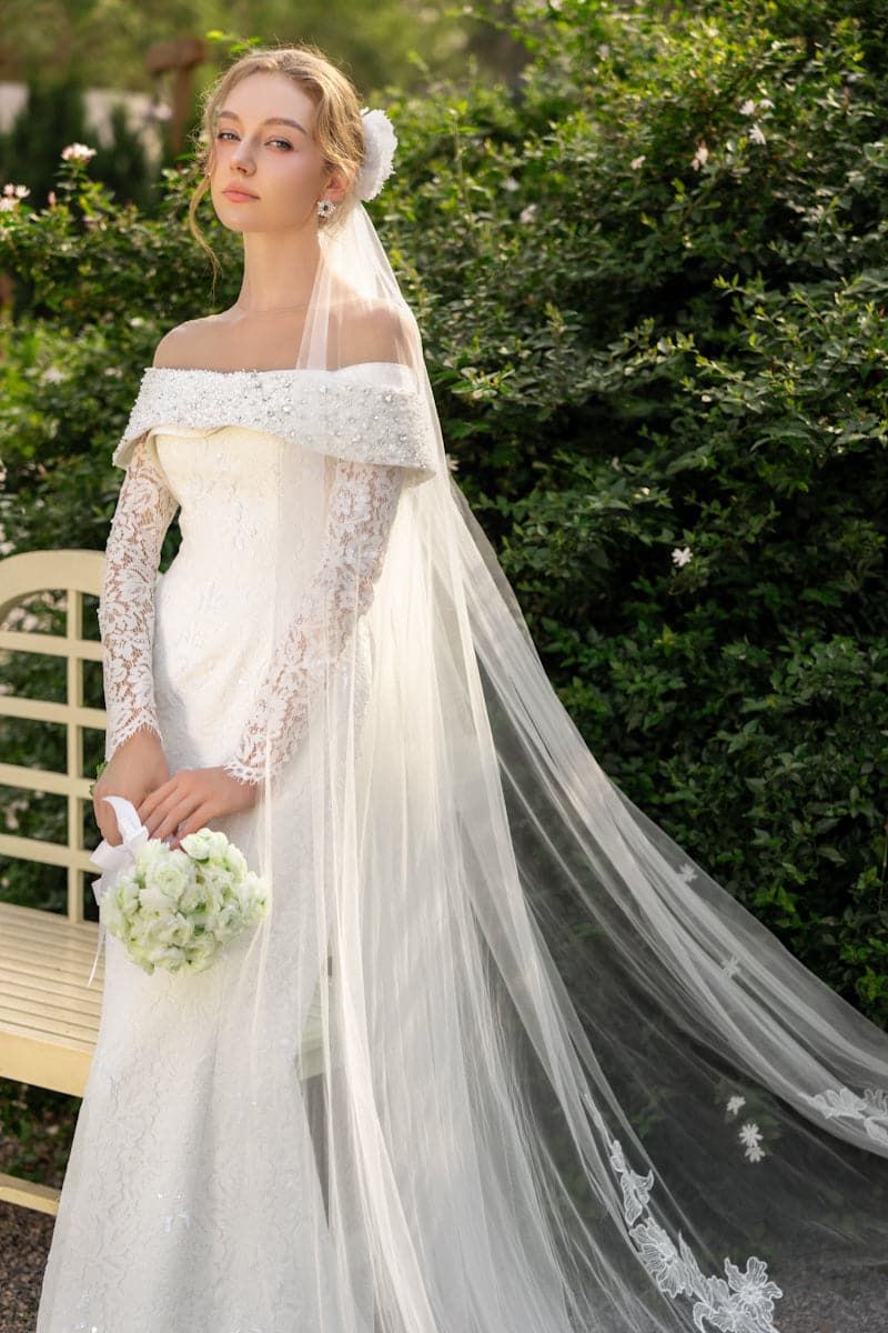 Elegant floral lace crystal gown by 21Six, featuring intricate lace details and a flowing silhouette for formal occasions.