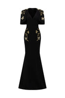 Black Isabelle crepe gown with Emmanuelle cape by 21Six, featuring flowing fabric and elegant design.