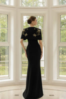 Black Isabelle crepe gown with Emmanuellette cape by 21Six, featuring elegant draping and sophisticated design.