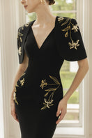 Black Isabelle crepe gown with Emmanuelle cape by 21Six, showcasing elegant flowing fabric and sophisticated design.