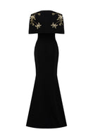 Black Isabelle crepe gown with Emmanuellee cape by 21Six, featuring elegant drape and flowing fabric for formal occasions.