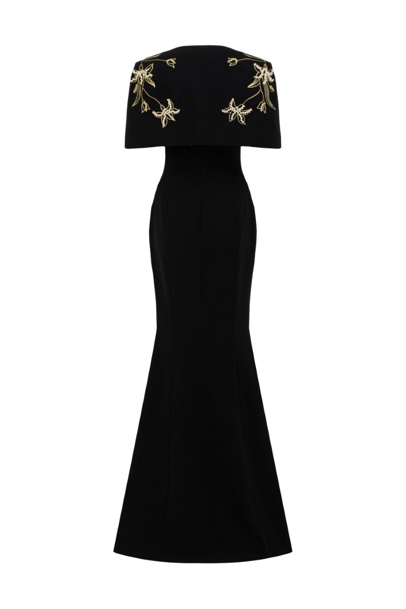 Black Isabelle crepe gown with Emmanuellee cape by 21Six, featuring elegant drape and flowing fabric for formal occasions.