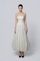 Elegant ivory Whisper gown by TONYY, featuring flowing fabric and delicate design, perfect for formal occasions.
