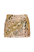 Gold embellished mini skirt by CEM featuring shiny gold accents and a fitted waistband, shown on a model.