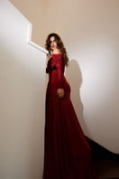 Deme By Gabriella Carla maroon draped gown with flowing fabric and elegant design, perfect for formal occasions.