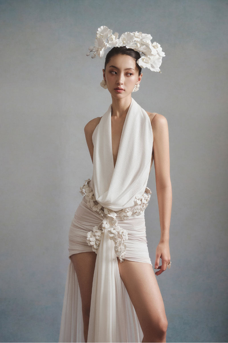 White Plan Seraphina draped mini dress with flowing fabric and elegant design, shown on a model.