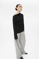 Dāl the Label modal asymmetric knit top featuring a stylish, draped design and long sleeves in soft, lightweight fabric.