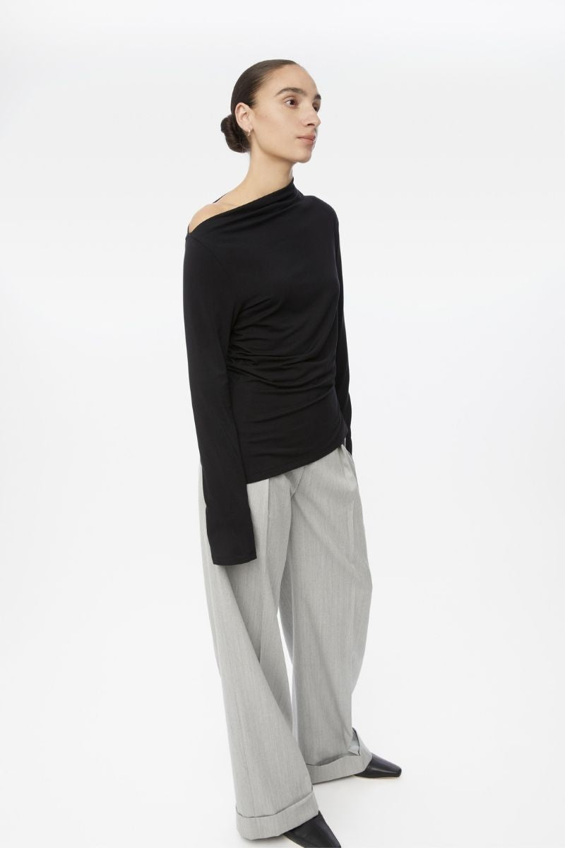 Dāl the Label modal asymmetric knit top featuring a stylish, draped design and long sleeves in soft, lightweight fabric.