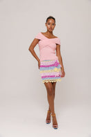 Handmade mini crochet skirt by Andreeva featuring a vibrant bird of paradise pattern, perfect for boho summer fashion.