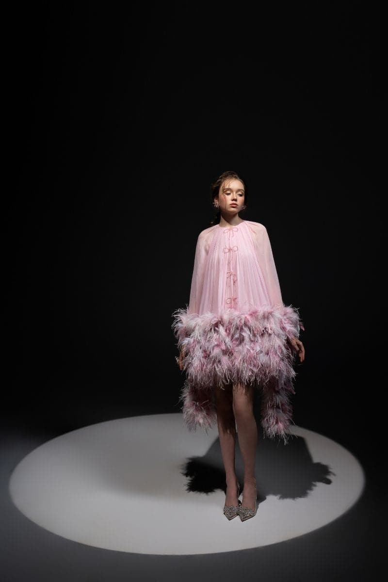 Pink ANNIE CHIFFON FUNNEL MINI DRESS by 21Six, showcased on a model, featuring a flowy chiffon fabric and a stylish funnel neckline.