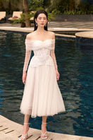 White Marilyn lace mixed tulle off-shoulder midi dress by 21Six, featuring elegant lace details and a flowing tulle design.