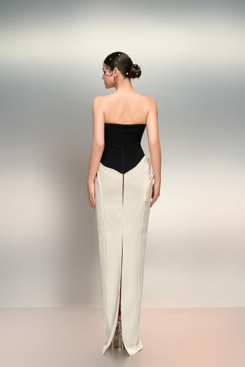 White and black Shamsa crepe and silk taffeta gown by 21Six, featuring elegant draping and a sophisticated design.