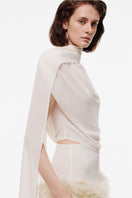 Off-white Kris Marán top with shawl, featuring a stylish, flowy design and elegant neckline.