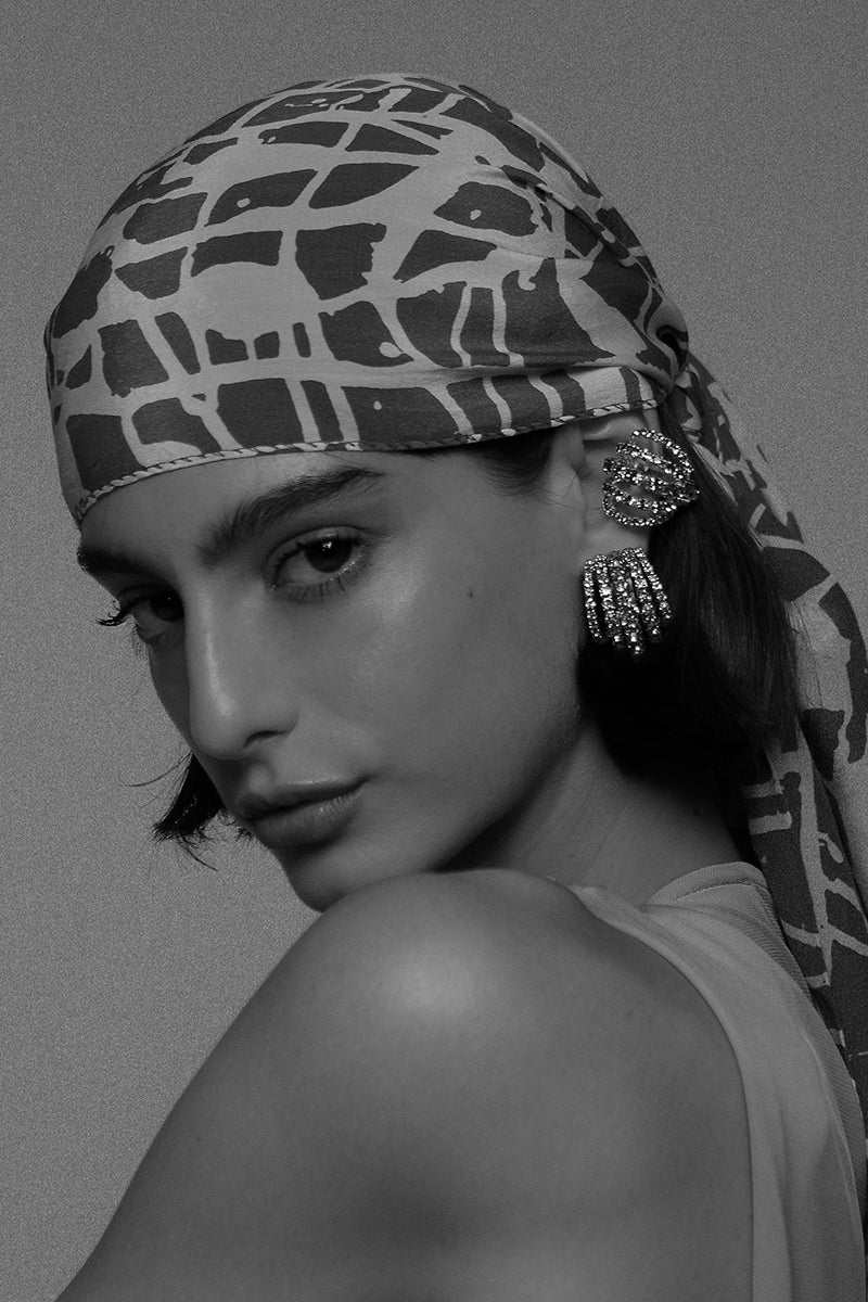 Silver mini shell earrings by Silvia Gnecchi featuring small, detailed shell designs suitable for everyday wear.
