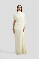 Deme By Gabriella Luciana maxi dress in off-white with flowing fabric and elegant design displayed in the image.