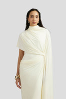 Deme By Gabriella Luciana maxi dress in off-white, flowing fabric with a relaxed, elegant silhouette and subtle detailing.