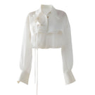 White sheer organza shirt by DOC BAN, showcasing lightweight, translucent fabric and classic button-down design.
