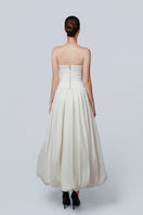 Ivory Whisper gown by TONYY, elegant dress with flowing fabric and delicate details, perfect for formal occasions.