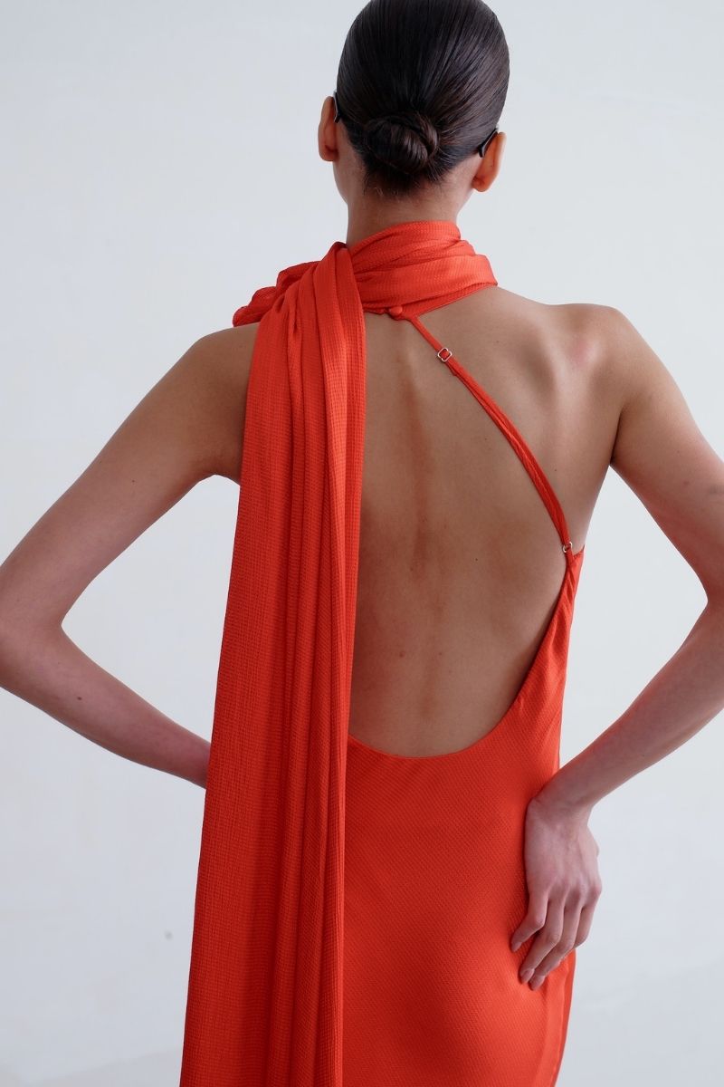 Red SISTERS Marilyn maxi dress with flowing fabric and sleeveless design, perfect for elegant occasions.