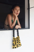 SAC DE SOUL leopard print shoulder bag in black and gold with a sleek design and gold-tone hardware.