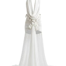 White Plan Seraphina draped mini dress shown hanging on a mannequin with flowing fabric and stylish design.