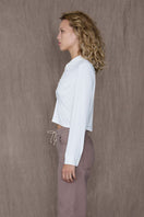 White GAB top by TT Studios, stylish sleeveless blouse with a relaxed fit, displayed on a hanger.