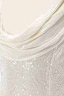 White Scylla dress by IKINITA, elegant gown with flowing fabric and stylish design, shown on a model.