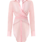 Pink Ulysse shirt by IKINITA, featuring a tailored fit and soft fabric, displayed hanging on a wooden hanger.