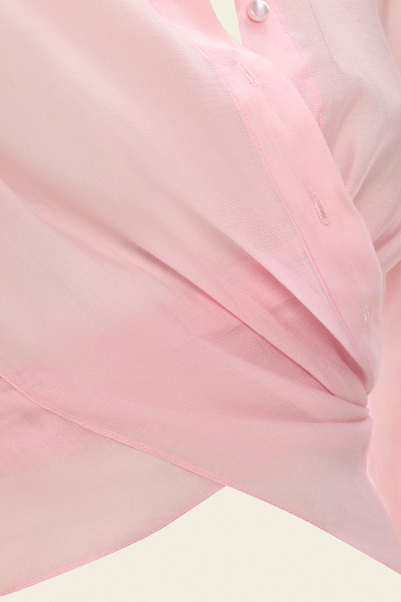 Pink Ulyssé shirt by IKINITA featuring a relaxed fit, long sleeves, and a classic collar, displayed on a hanger.