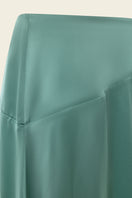 Emerald green NAUSICA midi skirt by IKINITA featuring a flowing silhouette and stylish waistband on a model.