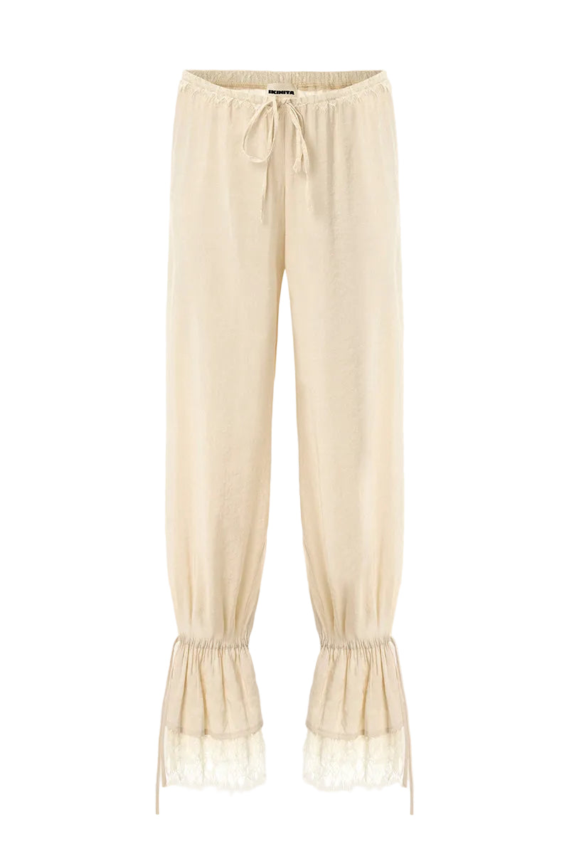 Cream SCYLLA pants by IKINITA, featuring a stylish design with a comfortable fit, displayed on a mannequin.