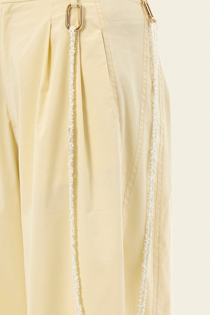 IKINITA ULYSSE yellow pants in butter yellow fabric, featuring a stylish, relaxed fit and modern design.