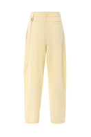 IKINITA ULYSSE yellow pants featuring a relaxed fit and soft butter yellow fabric, styled for casual wear.