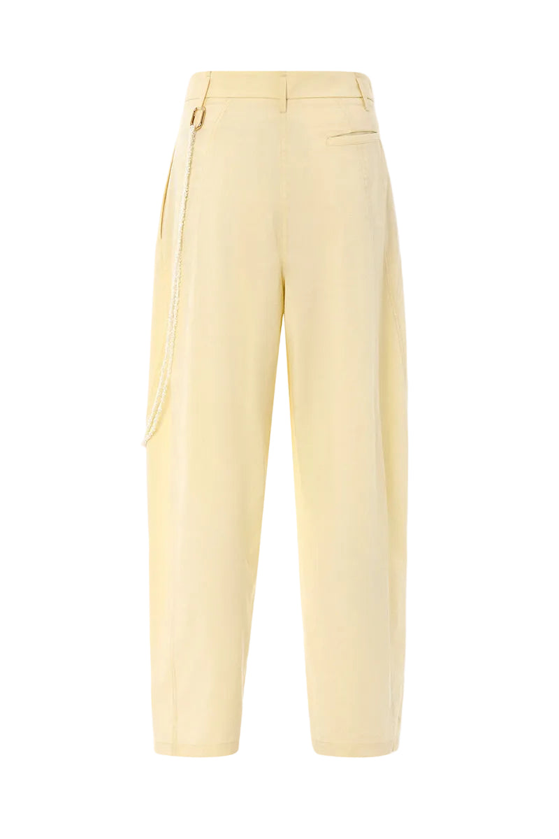 IKINITA ULYSSE yellow pants featuring a relaxed fit and soft butter yellow fabric, styled for casual wear.