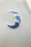 Blue wave top by IKINITA, featuring a stylish and flowing design, shown on a model with a relaxed fit and vibrant color.