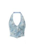 Blue IRIS top by IKINITA, featuring a stylish design, shown on a model with a relaxed fit and modern look.