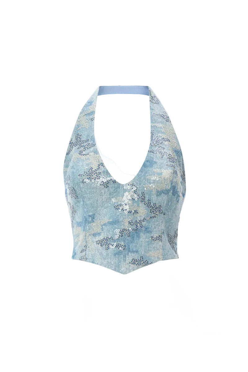 Blue IRIS top by IKINITA, featuring a stylish design, shown on a model with a relaxed fit and modern look.