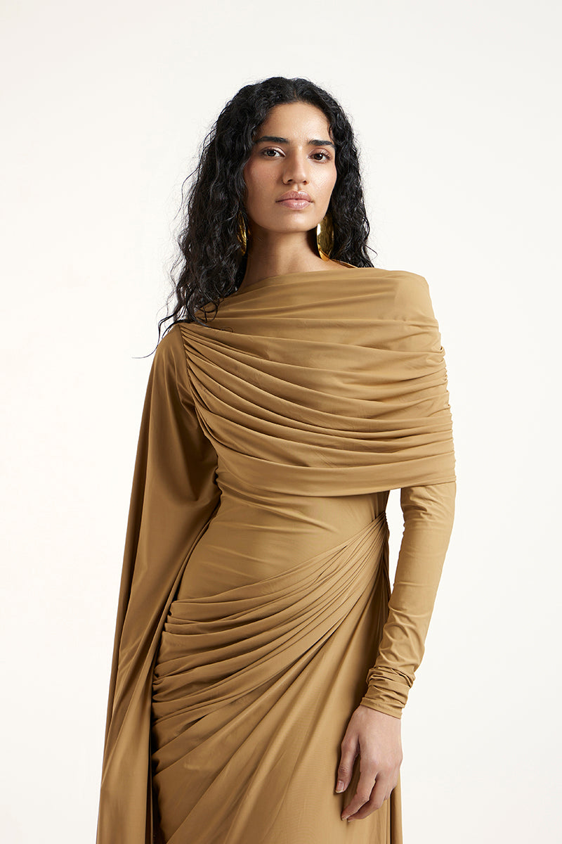 Deme By Gabriella Suze Maxi Dress in dark beige with flowing fabric and elegant design, perfect for stylish occasions.