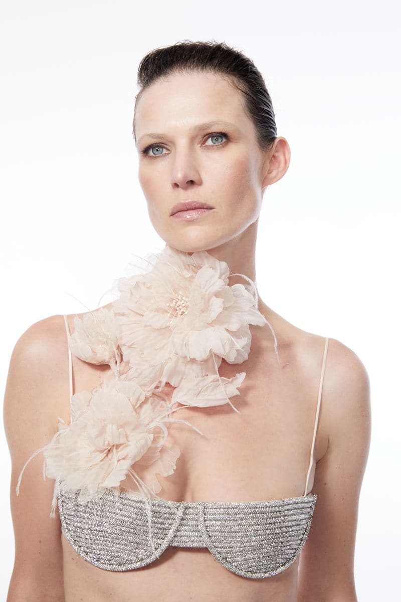 Nué Midnight Rhinestone Bra top with sparkling embellishments, shown on a hanger against a neutral background.
