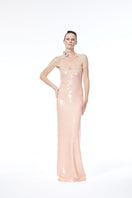 Nué BARE glossy sequin gown with a fitted silhouette and shimmering embellishments, perfect for formal occasions.
