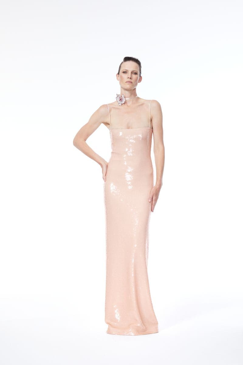 Nué BARE glossy sequin gown with a fitted silhouette and shimmering embellishments, perfect for formal occasions.