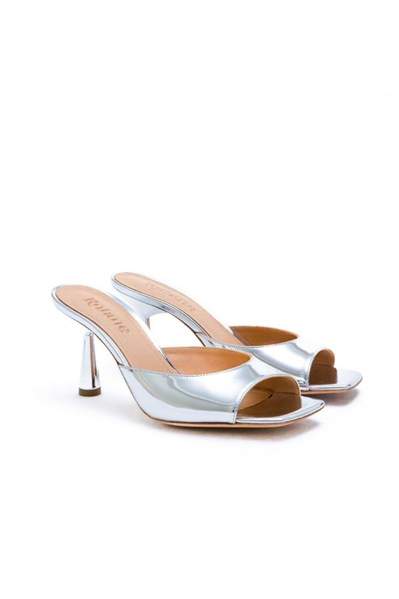 Kolane Greta Silver Mule Sandals featuring sleek metallic design and comfortable slip-on style.