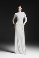 White Corvina draped floor-length gown by Maison Des Copains, elegant design with flowing fabric and sophisticated style.