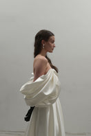 Off-White Volume Sculpted Gown by Monetre, featuring a flowing, sculpted design in a luxurious fabric, worn by a model on the runway.