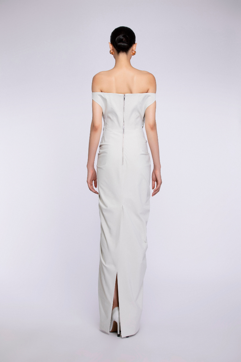 Ivory maxi dress by TONYY with flowy fabric and sleeveless design, perfect for elegant summer occasions.