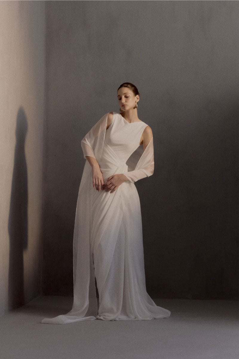 Elegant White Plan Regent gown with flowing fabric and intricate detailing, perfect for formal occasions.