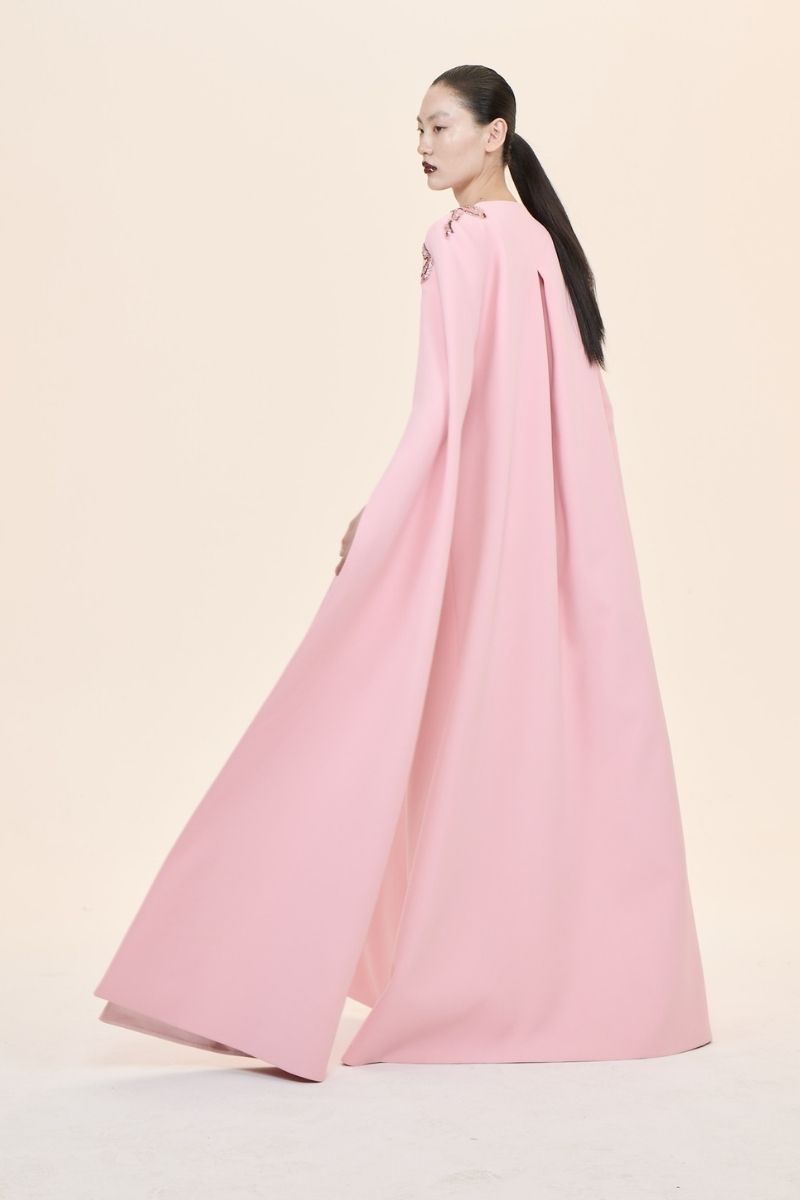 Nihan Peker Aura Pink Cape Gown displayed on a mannequin, featuring flowing fabric and elegant design for formal occasions.