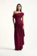 Deme By Gabriella Cassidy maxi dress in aubergine, flowing fabric with a stylish silhouette, displayed on a hanger.