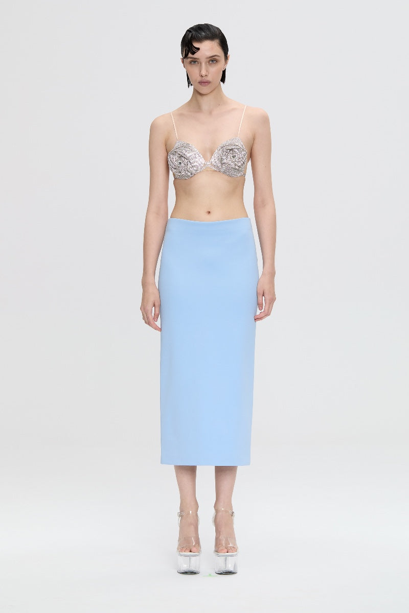 Nué Delphine midi skirt with floral pattern, lightweight fabric, and high-waisted design, perfect for resort and casual wear.